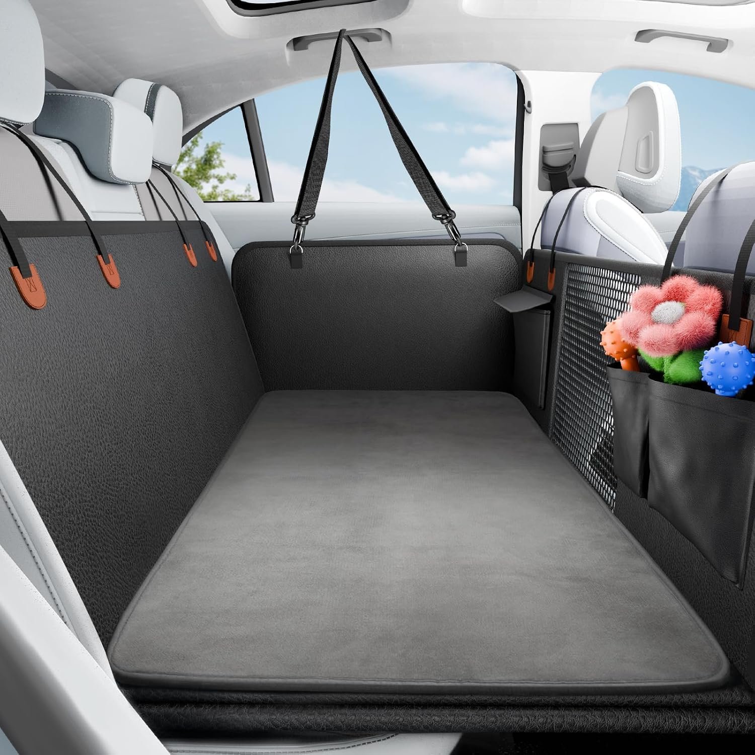 SummitGo black PU leather back seat extender with mesh window and storage pockets installed in a car