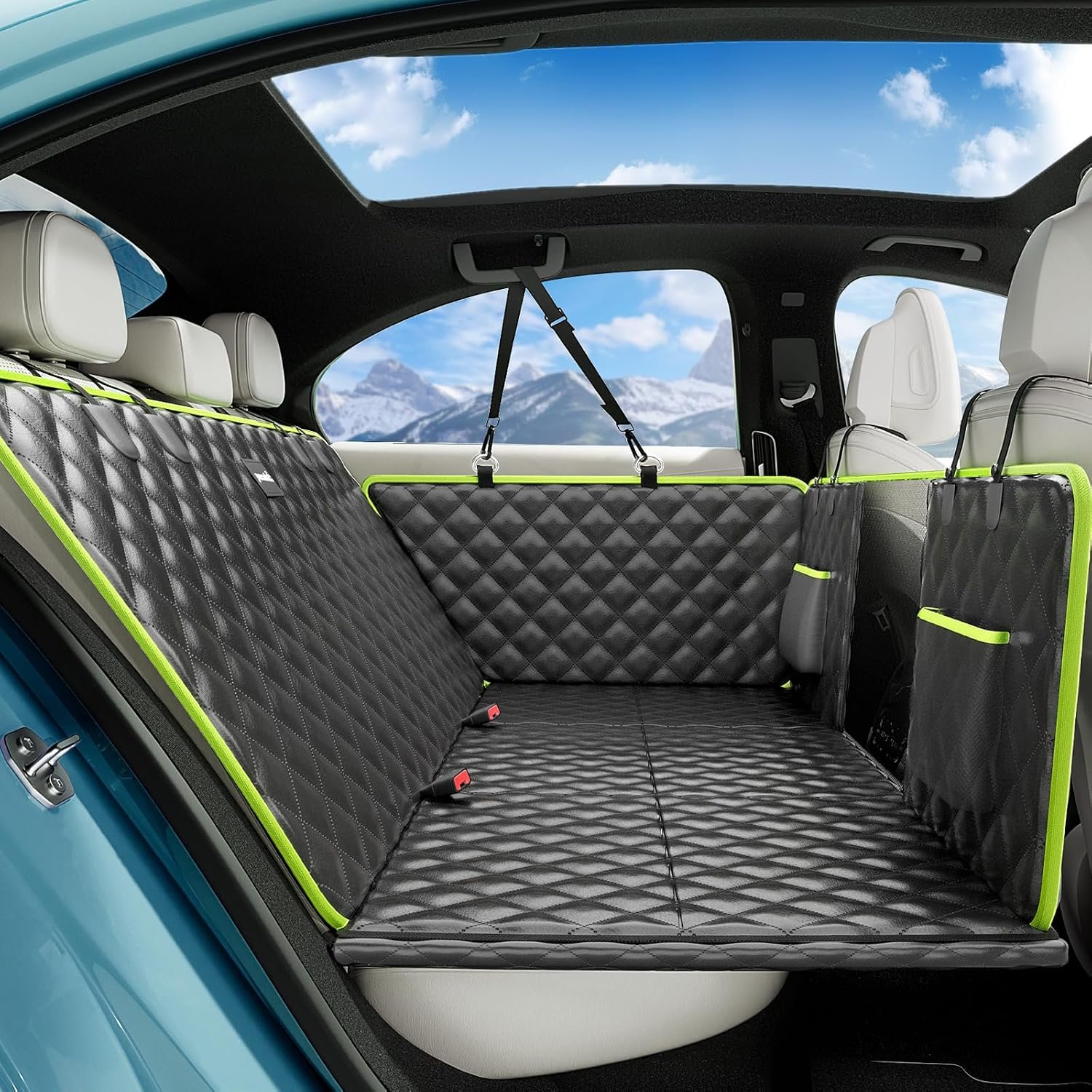 Pecute black leather back seat extender with green trim installed in a car back seat