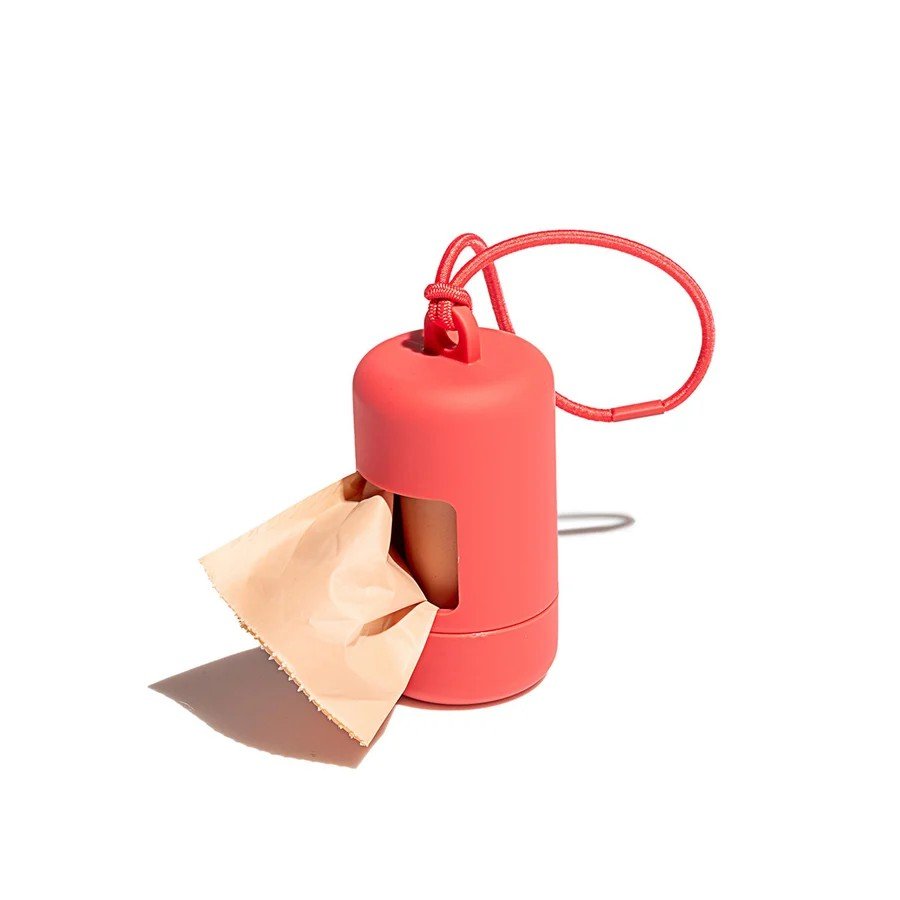 Wild One soft-touch dog poop bag holder in coral red with elastic leash loop