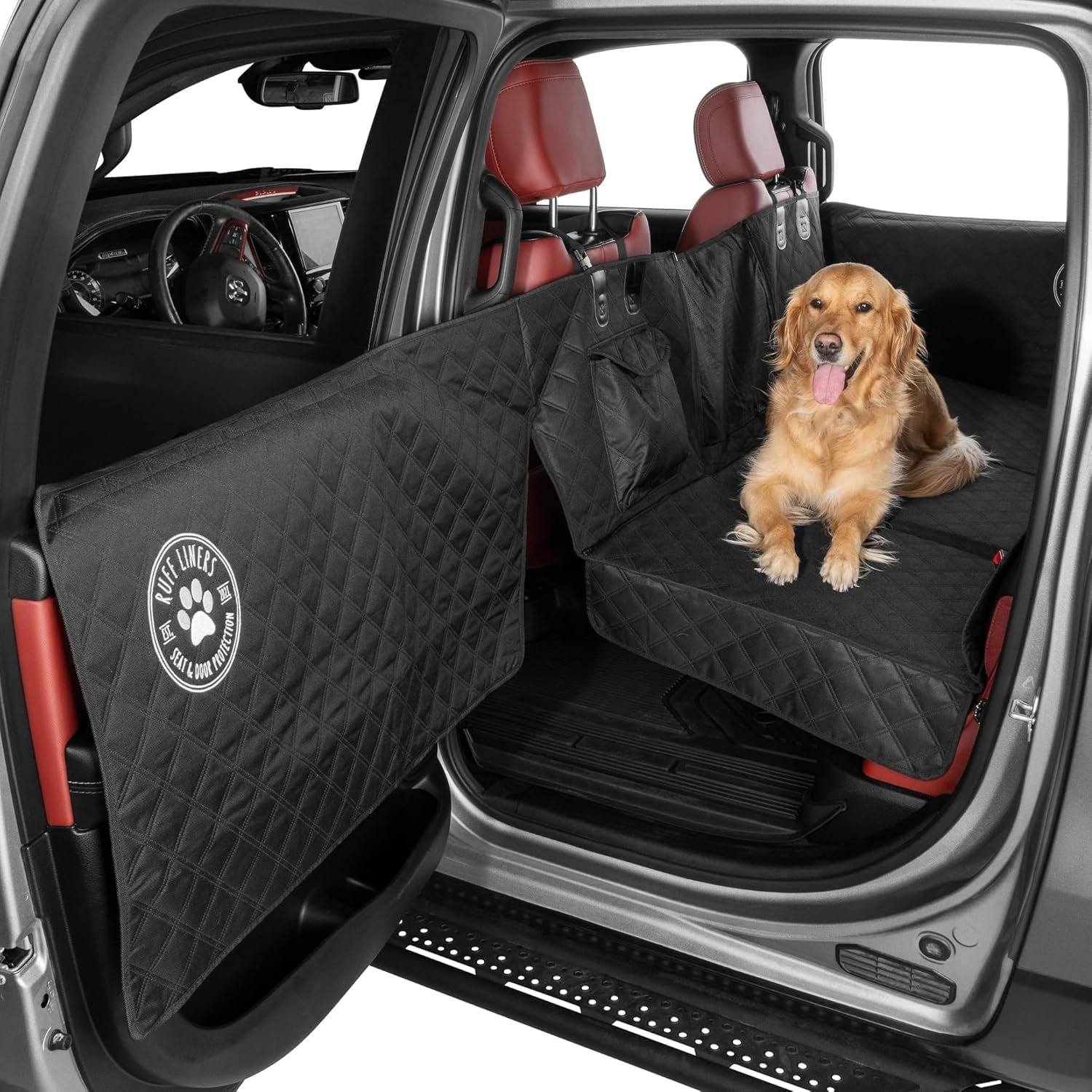 Ruff Liners medium back seat extender installed in a truck back seat with quilted door panel cover, a golden retriever lying on the hard-bottom platform